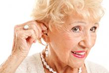 mature woman inserts hearing aid.jpg